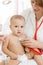 Pediatrician doctor with baby in medical room