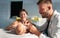 Pediatrician doctor examines baby with stethoscope checking heart beat.