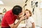 Pediatrician doctor examining child. Male doctor examining boy's ear with otoscope in hospital.