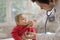 Pediatrician doctor is examining child with stethoscope