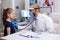 Pediatrician doctor examining little girl with stethoscope for disease