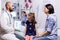 Pediatrician doctor explaining mother radiography resultes for sick child