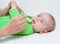 Pediatrician examines a newborn baby with a spatula