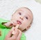 Pediatrician examines a newborn baby with a spatula