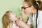 Pediatrician examining girl\'s throat