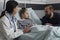Pediatrician examining ill kid health condition while discussing with parent