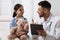 Pediatrician explaining examination result to little girl in hospital