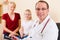 Pediatrician with family in his surgery