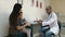 Pediatrician filling in medical form and giving pills to mother and her little daughter