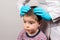 The pediatrician in the gloves will check the presence of lice and nits in a small child. Pediculosis in kindergarten, preventive