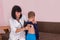 Pediatrician listening boy`s breathing with stethoscope on back