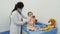 The pediatrician listens to the child with a stethoscope. Doctor uses a stethoscope to check the health of a baby.