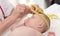 Pediatrician measuring head of baby