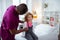 Pediatrician measuring temperature for little cute girl