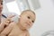 Pediatrician taking baby\'s temperature in ear