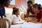 Pediatrician Visiting Parents And Child In Hospital Bed