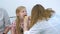 Pediatrician woman looking child girl sore throat using spatula and lantern.