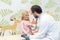 Pediatrist listening to breath of little girl