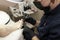 Pedicure in a beauty salon. A masked and gloved craftsman varnishes the clientâ€™s nails. Close-up