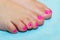 Pedicure with bright colored gel polish. Neat well-groomed toes.
