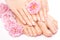 Pedicure and manicure with a pink rose flower