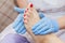 Pedicure moisturizing cram after dead skin remover foot rasp woman in nail salon.