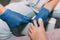 Pedicure process in salon. Foot care treatment and nail. Removing dead skin with forceps. Master in blue gloves makes pedicure wit