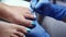 The pedicure technician is polishing nails in a beauty salon