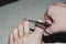 Pedicure, toenail clipping with small scissors