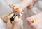 Pedicurist applying nail polish, close up photo