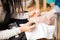 Pedicurist applying nail polish to some toenails