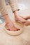 Pedicurist cleansing customer feet