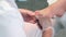 Pedicurist master woman is cutting nails on toes using metal tweezers, closeup.