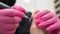 A pedicurist treats the toes of a client using a machine with an abrasive disc in a beauty salon.