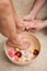 Pedicurist washing a customers feet