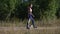 pedigree canine concept of young sport thin female walking with small dog in green summer park path during outdoor