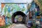 Pedley Street Arch, Shoreditch, East London. Pedestrian Alleyway under railway line near Brick Lane, covered in colourful graffiti