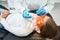 Pedodontist in nitrile gloves inspecting child oral cavity