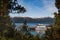 Peekaboo view of ferry by the pier on the mountain lake