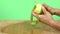 Peel a green apple with a knife in a studio