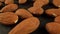 Peeled almonds on the dark surface of the table, studio lighting. Sweet almonds ready to eat. Natural ingredients.