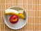 Peeled banana and apple inside white bowl