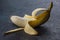 Peeled banana on black wooden rustic vintage table. Peel banana Turkish Anamur