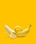 Peeled banana on yellow background