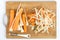 Peeled carrots and parsnips on the cutting wooden board