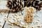 Peeled cedar nuts in a jar on the old wooden table against the b