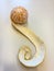 Peeled clementine with curved peel on white background