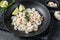 Peeled cooked Shrimps, Prawns in a plate. Black background. top view