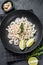 Peeled cooked Shrimps, Prawns in a plate. Black background. top view