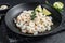 Peeled cooked Shrimps, Prawns in a plate. Black background. top view